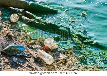 Environmental Water Pollution. Polluted River - Dirty Green Water, Garbage, Waste And Trash. Harmful