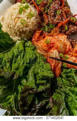 Korean Beef Bulgogi Ssambap Lettuce Wraps With Spicy Kimchi And Gochujang Hot Sauce