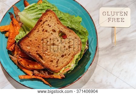 Deli Chicken Guacamole Sandwich On Gluten-free Sliced Bread With Sweet Potato Fries