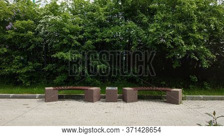Two Wooden Benches Next To Each Other.