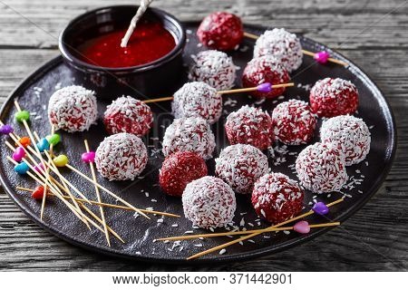 Low-calorie Dessert: Berry Bliss Balls With Desiccated Coconut Mixed With Peanut Butter And Fresh Mi