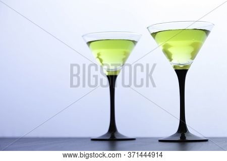Two Yellow Cocktails Glasses On White