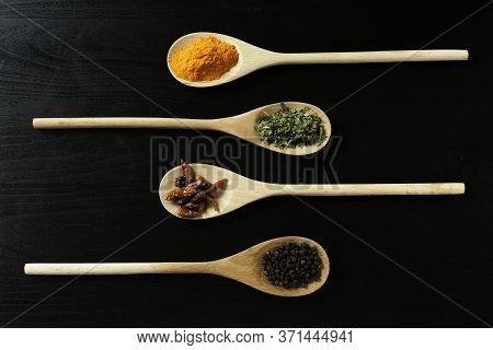 Four Wooden Spoons With Spices