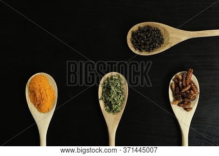 Three More One Wooden Spoons In Line With Assorted Spices