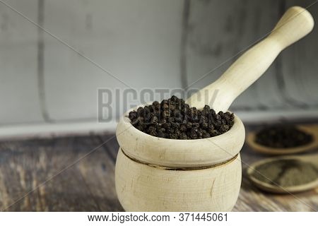 Wooden Mortar Filled With Peppercorns  Close-up