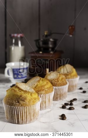 Four Delicious Cupcakes And Milk Bottle