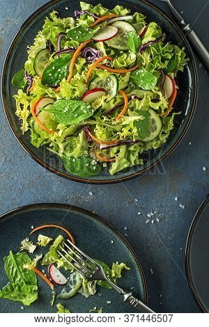 Green Lettuce Salad Meal With Fresh Mixed Vegetables On Blue Table Background
