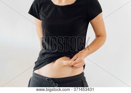 Young Woman Holding Her Belly Fat. Weight Access, Diabetic Tummy. Postpartum Figure