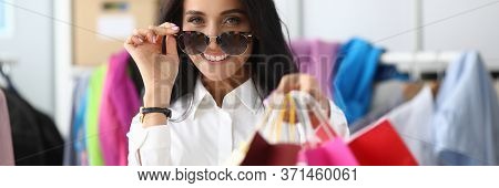 Woman Adjusts Glasses From Sun Showing Packages. Shopper Selectos Outfits For Client. Boutique Consu