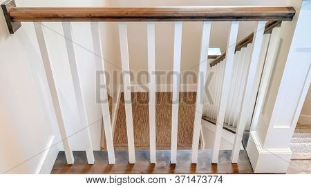 Panorama Crop U Shaped Stairway Of Home With Brwon Handrail Supported By White Balusters