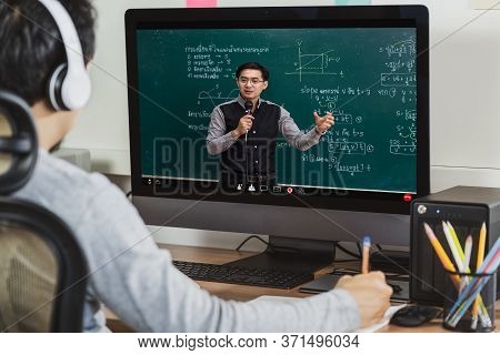 Rear View Of Asian Student Learning With Teacher Over The Physics Formular In Thai Laguage On Black 