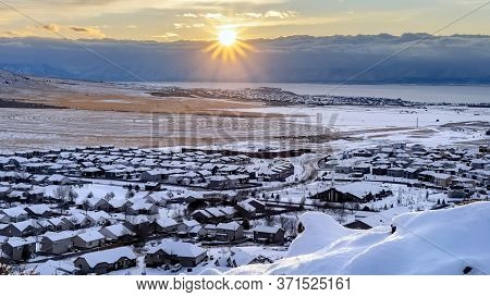 Panorama Frame Beautiful Sunrise In Draper Utah With Snowy Hills Lake And Houses In Winter