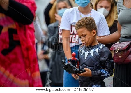 Richmond, North Yorkshire, Uk - June 14, 2020: A Young Superhero Plays With His Action Figures While