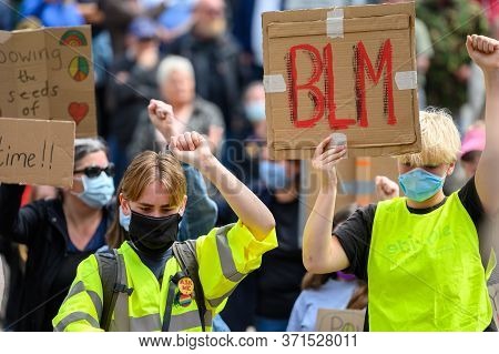 Richmond, North Yorkshire, Uk - June 14, 2020: Caucasian Protesters Wear Ppe Face Masks, Salute And 