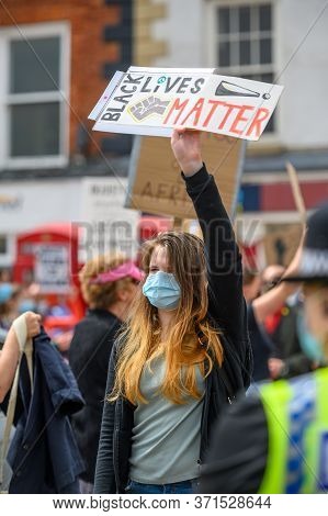 Richmond, North Yorkshire, Uk - June 14, 2020: Female Protester Wears A Ppe Face Mask And Holds A Ho