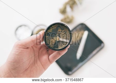 Grinder And Cannabis Weed Bud. White Background. Marijuana Nature Bud. Kief In Grinder.