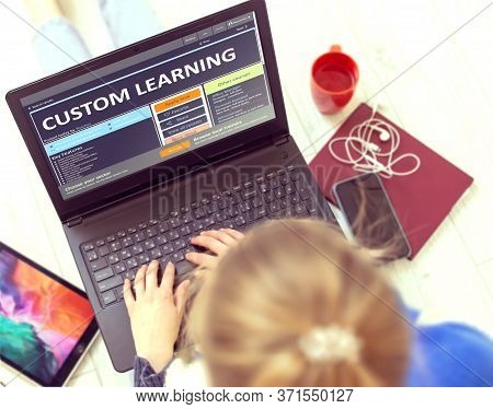 Custom Learning. Girl Sitting On Floor And Using Modern Portable Notebook In Home Indoors. Young Wom