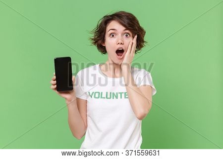 Amazed Woman In Volunteer T-shirt Isolated On Pastel Green Background. Voluntary Free Work Assistanc