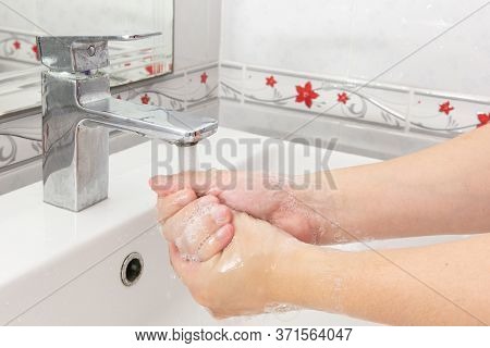 Both Hands Are Washing Their Hands In The Sink.hygiene Concept.