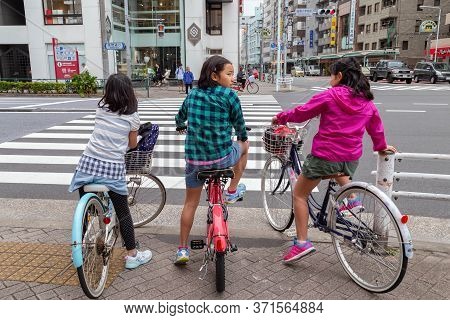 Tokyo, Japan - June 15, 2020 : Three Japanese Girl Friend Children Are Ride Bicycle And Stop On Pede