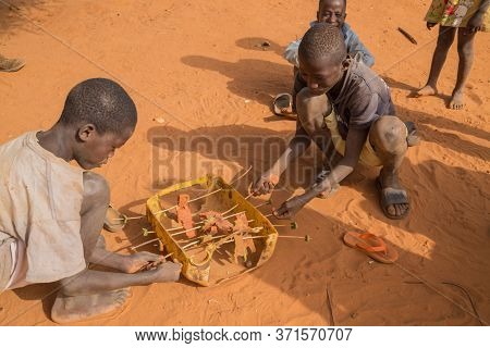 Bissau, Guinea-Bissau - January 5, 2020: group of African Kids playing with a made toy, in rural Guinea-Bissau