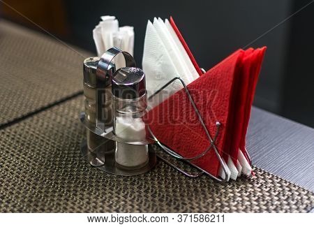 Breakfast Scene At A Diner With Salt And Pepper Shakers, Silverware, And Coffee