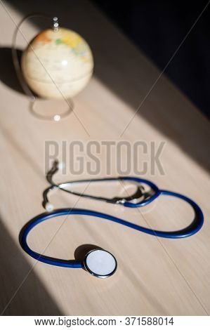 Globe And Stethoscope. The Concept Of Global Warming And Pollution. Phonendoscope And Earth Miniatur