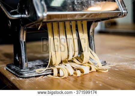 Chef Rolling Dough With A Pasta Machine. Pasta Maker Machine.