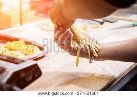 Chef Rolling Dough With A Pasta Machine. Pasta Maker Machine.