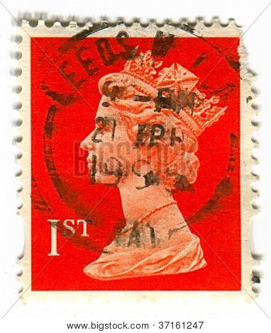 UK-CIRCA 1990:A stamp printed in UK shows image of Elizabeth II is the constitutional monarch of 16 sovereign states known as the Commonwealth realms, in red, circa 1990.