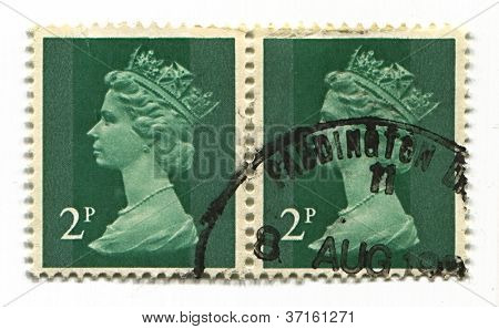 UK-CIRCA 1990:A stamp printed in UK shows image of Elizabeth II is the constitutional monarch of 16 sovereign states known as the Commonwealth realms, in green, circa 1990.