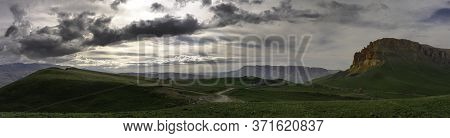 Mountains Above Green Meadows Under A Blue Sky