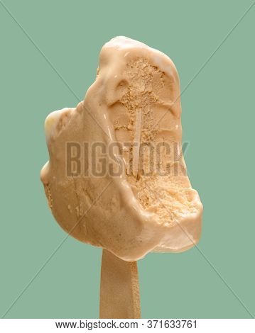 Cheese And Lemon Flavor Popsicle With The Last Bit On Green Background