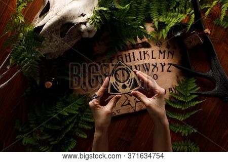 Mystic Ritual With Ouija And Candles. Devil's Board Concept, Black Magic Or Fortune Telling Rite Wit