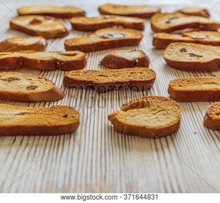 Wheat Rusks On A Wooden Background. Background From Rusks. Photographed Close-up.