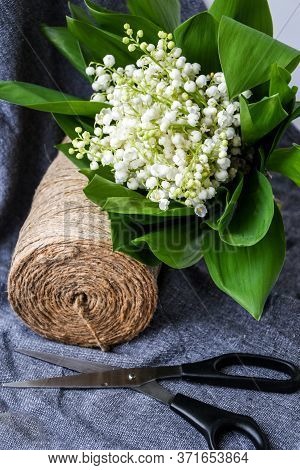 Spring Bouquet Of Lilies Of The Valley With Scissors Rope In A Flower Shop, White Flowers And Green 