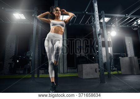 From Above View Of Female Bodybuilder In Sportswear Leaning On Parallel Bars. Srtong Woman With Perf