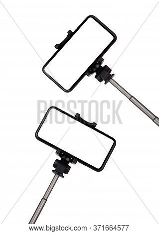Smartphone With A White Cut-out Screen On A Monopod. Selfie Stick And Smartphone On A White Backgrou