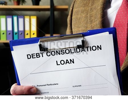 Banker Offers Debt Consolidation Loan Documents For Filling In.