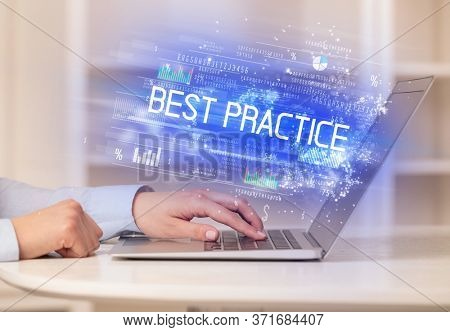 Closeup of businessman hands working on laptop with BEST PRACTICE inscription, succesfull business concept