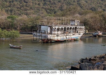 MUMBAI, INDIA - FEBRUARY 15, 2020: Abandoned tourist boat on Elefanta Island near Mumbai, India