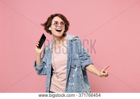 Funny Young Brunette Woman In Casual Denim Jacket Eyeglasses Isolated On Pastel Pink Background. Peo