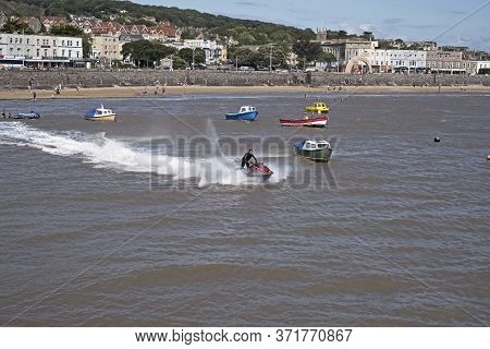 Weston-super-mare, Uk - July 28, 2019: A Jet Ski Leaves Knightstone Harbour.