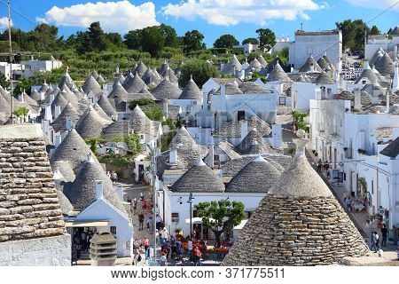Alberobello, Italy - May 29, 2017: People Visit Alberobello, Italy. Alberobello And Its Trulli House