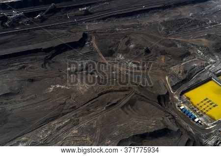 Top View On A Pool With Yellow Liquid Used In A Coal Mining In A Quarry. Heavy Industry Concept