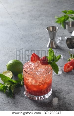 Freshness Alcohol Cocktail With Gin, Strawberries, Soda, Ice Cube And Lime. Tasty Beverage With Inge