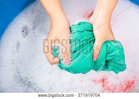 Closeup Young Asian Woman Use Hands Washing Color Clothes In Basin. Female Squeeze Wring Out Wet Fab