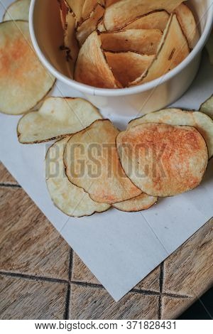 Fresh Homemade Deep Fried Crispy Potato Chips In White Box On A Wooden Background, Top View. Salty C