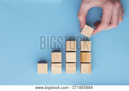 Hand Choosing A Wooden Block From A Set. Business Choice Concept