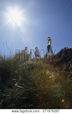 Father with two sonson mountain top low angle vieW